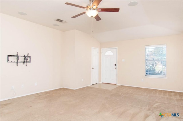 unfurnished room featuring lofted ceiling, visible vents, ceiling fan, and light carpet