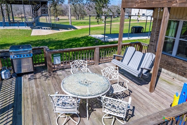 wooden deck featuring grilling area and a yard