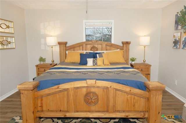 bedroom with dark hardwood / wood-style floors