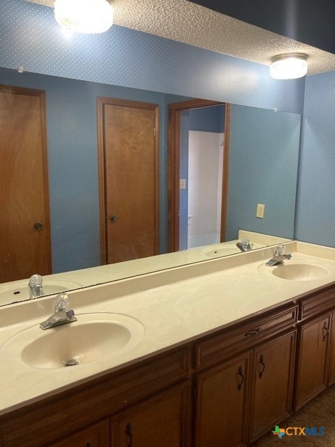 bathroom with vanity and a textured ceiling