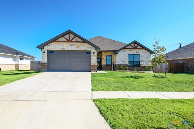 craftsman inspired home with a garage and a front lawn