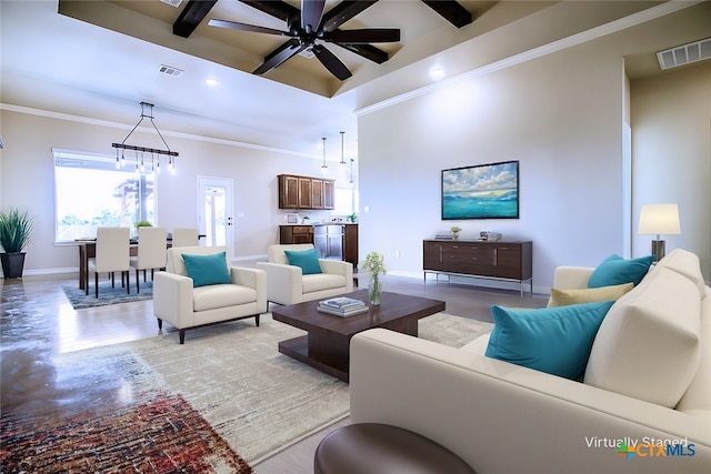 living room featuring ceiling fan with notable chandelier, light hardwood / wood-style flooring, crown molding, and beam ceiling