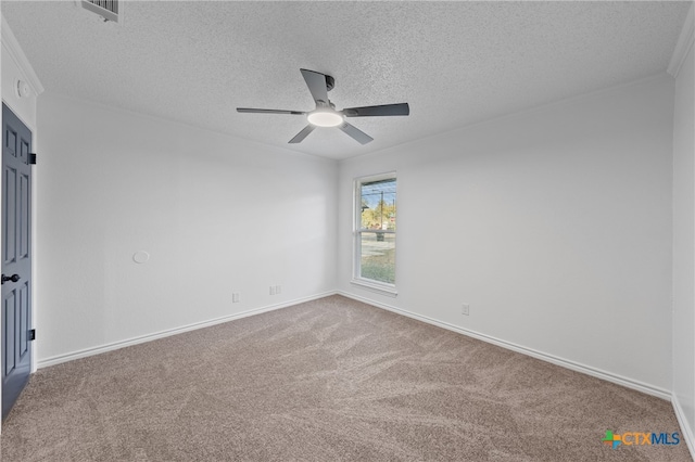 carpeted spare room featuring ceiling fan and a textured ceiling