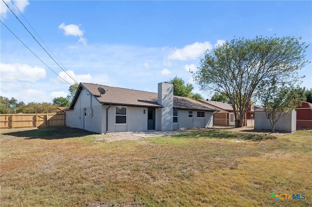 rear view of house with a yard