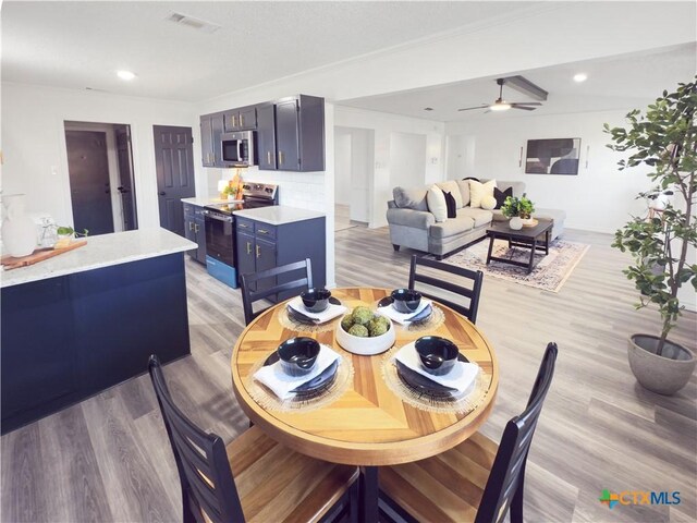 kitchen featuring stainless steel appliances, tasteful backsplash, light hardwood / wood-style floors, and sink