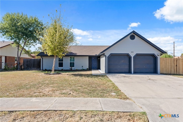 single story home featuring a front lawn and a garage