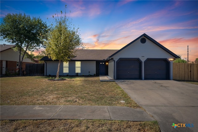 ranch-style home with a lawn and a garage