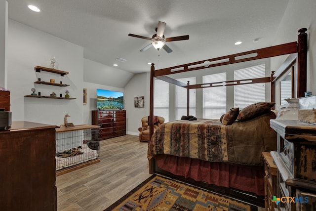 588 Vale Ct, New Braunfels, TX 78132 - bedroom featuring light wood-type flooring, multiple windows, a textured ceiling, and lofted ceiling