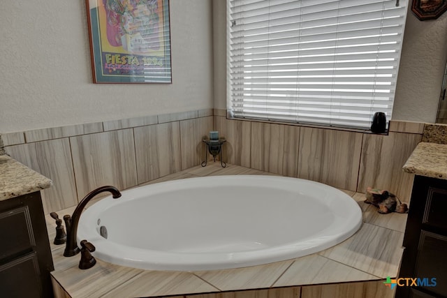 588 Vale Ct, New Braunfels, TX 78132 - bathroom featuring vanity and tiled tub