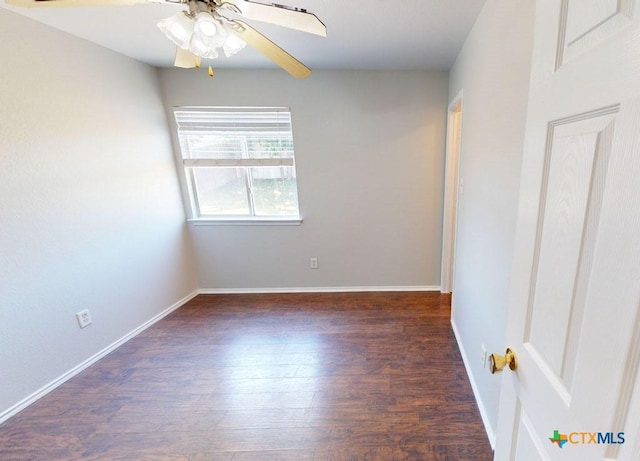 empty room with dark hardwood / wood-style flooring and ceiling fan