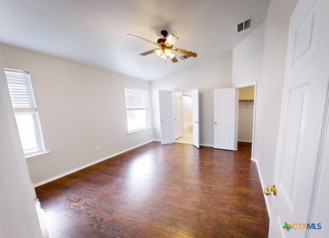 unfurnished bedroom featuring ceiling fan, dark hardwood / wood-style floors, and lofted ceiling