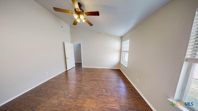 empty room featuring ceiling fan, dark hardwood / wood-style flooring, and vaulted ceiling