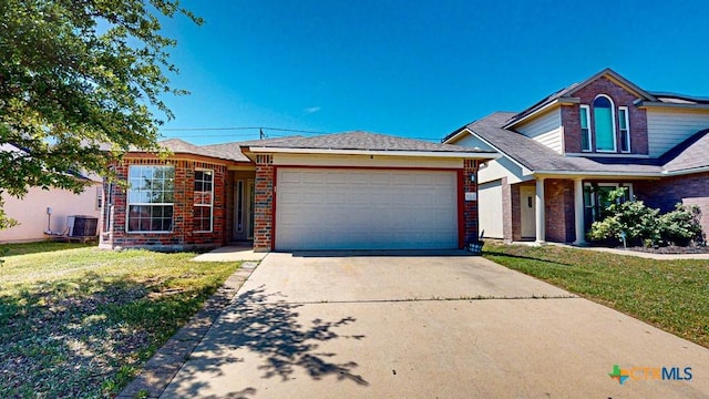 view of front of property featuring a front lawn, a garage, and cooling unit