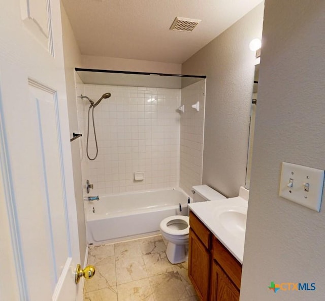 full bathroom featuring vanity, toilet, and tiled shower / bath combo