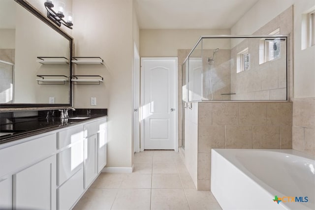 bathroom featuring independent shower and bath, tile patterned flooring, and vanity