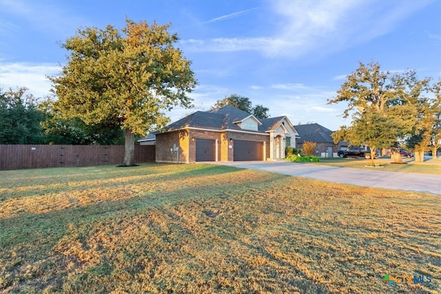 view of front of property with a garage and a front yard