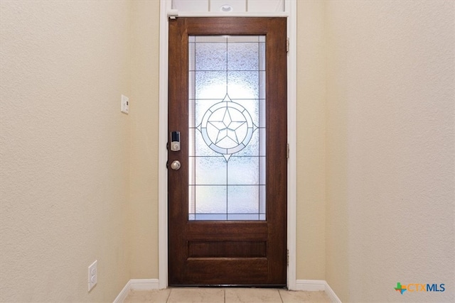 tiled entryway with a wealth of natural light