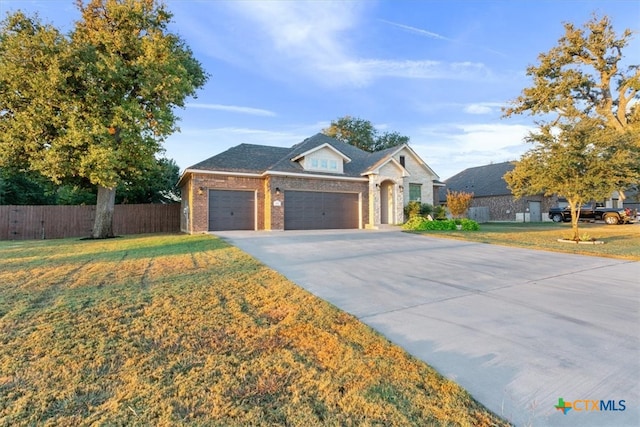 view of front facade with a garage and a front lawn