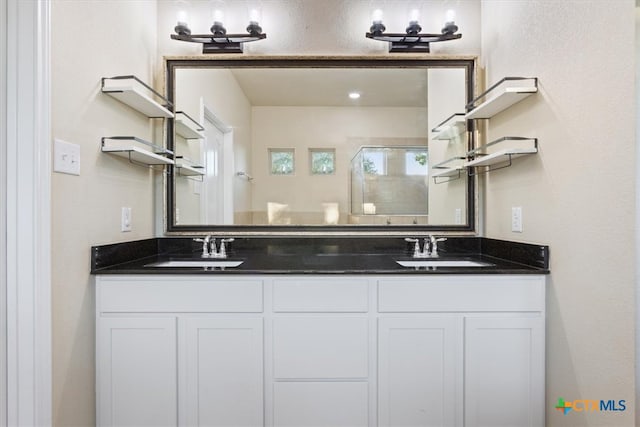 bathroom featuring an enclosed shower, a wealth of natural light, and vanity