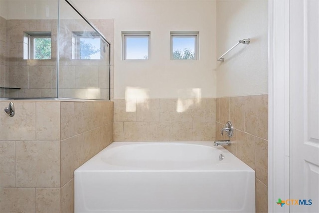 212 Lasata Ln, Belton, TX 76513 - bathroom with a bath, tile walls, and tiled shower