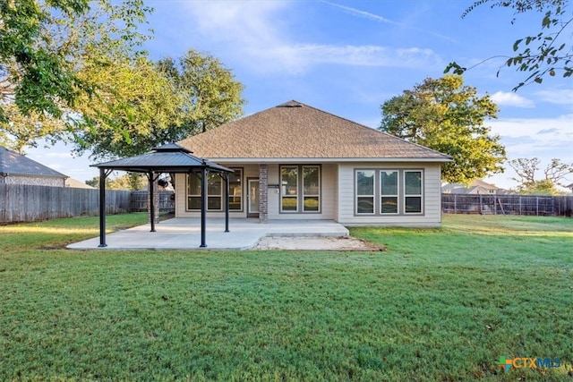 back of property with a yard, a gazebo, and a patio area