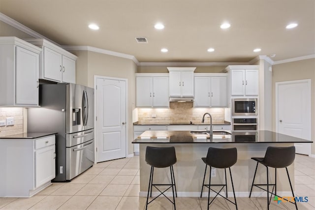 kitchen featuring white cabinetry, appliances with stainless steel finishes, sink, and light tile patterned floors