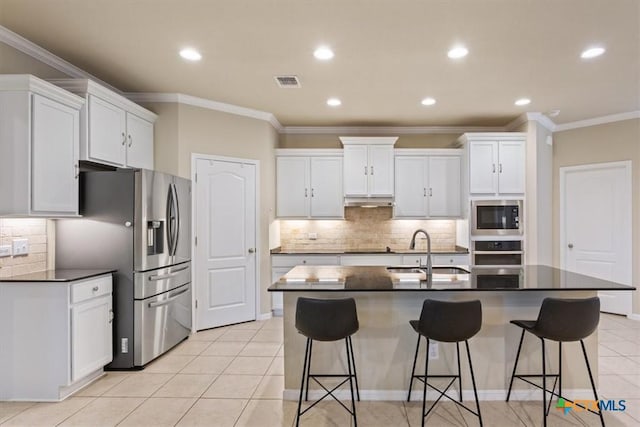 212 Lasata Ln, Belton, TX 76513 - kitchen featuring a sink, appliances with stainless steel finishes, dark countertops, white cabinetry, and ornamental molding