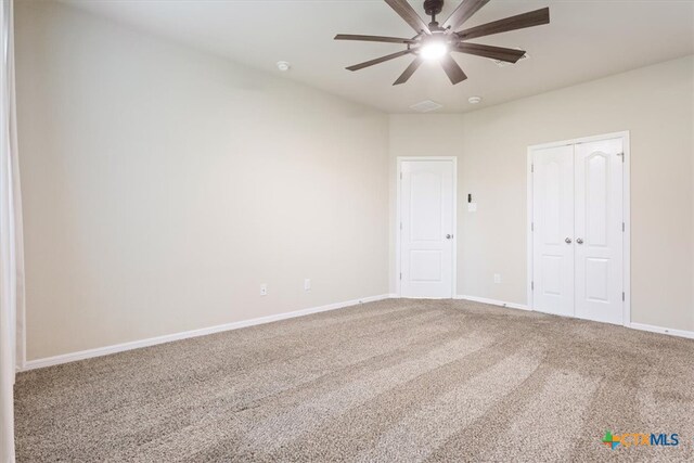 empty room with carpet flooring and ceiling fan