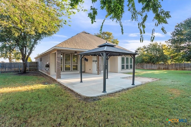 back of house with a yard, a gazebo, and a patio area