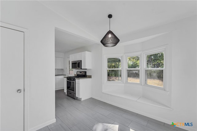 kitchen featuring white cabinetry, pendant lighting, and stainless steel appliances