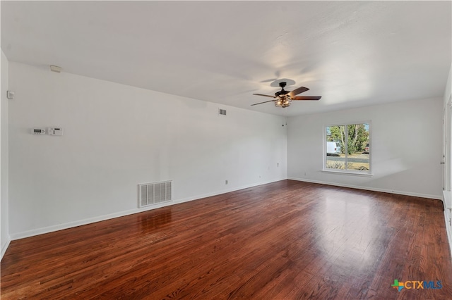 spare room featuring ceiling fan and dark wood-type flooring