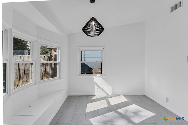 unfurnished sunroom with vaulted ceiling