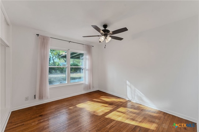 spare room with ceiling fan and hardwood / wood-style flooring