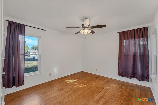 spare room with light hardwood / wood-style floors and ceiling fan