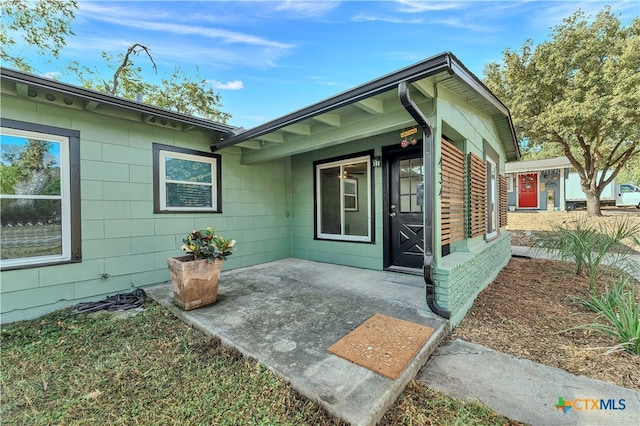 property entrance with a patio