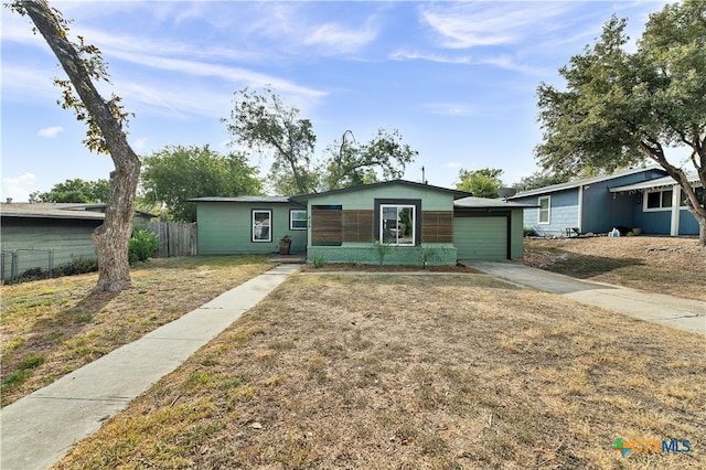 ranch-style home with a garage and a front yard