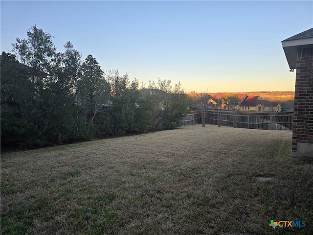 view of yard at dusk