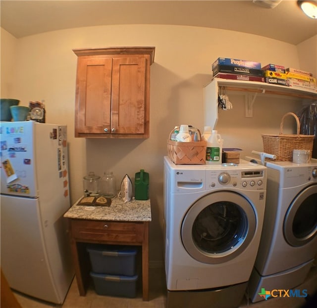 clothes washing area with washer and clothes dryer