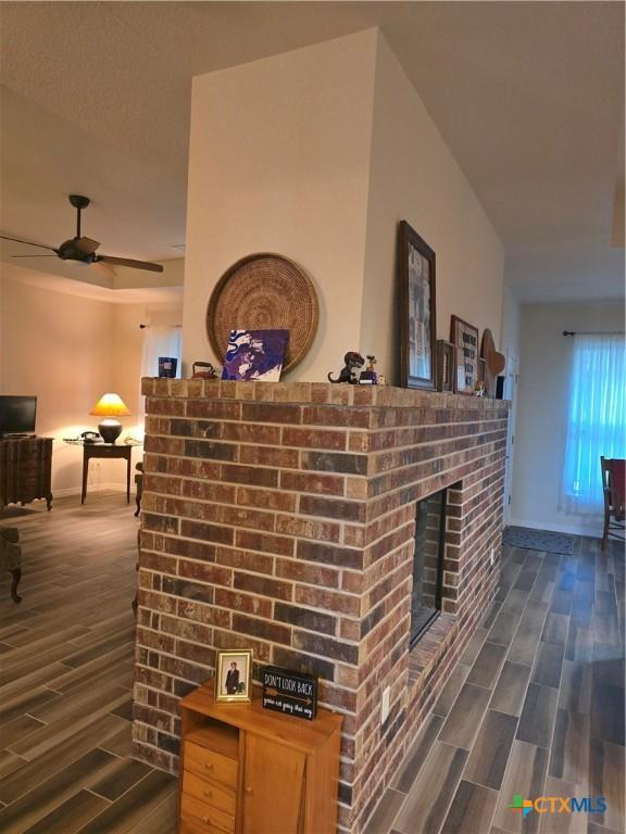 interior details with a fireplace and ceiling fan