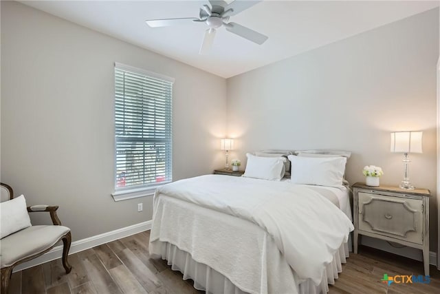 bedroom featuring ceiling fan, baseboards, and wood finished floors