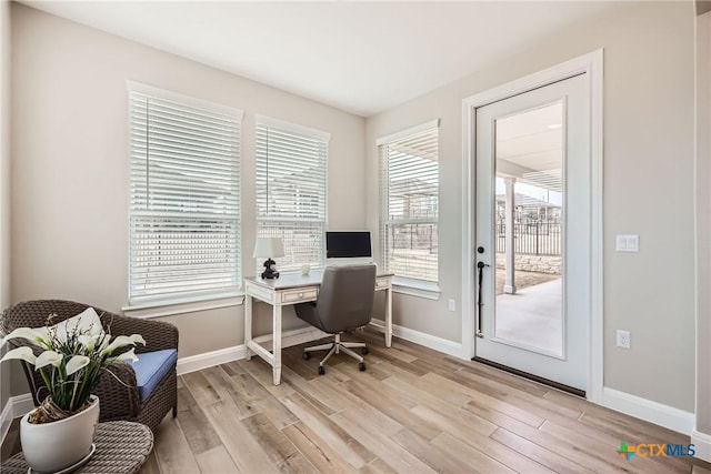 office with light wood-style flooring and baseboards