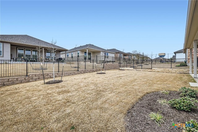 view of yard featuring a residential view and fence