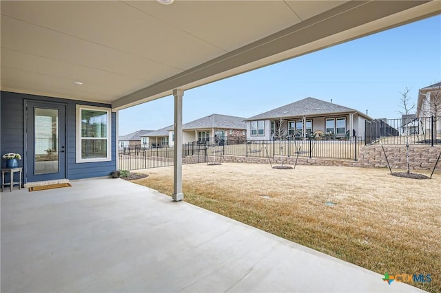 view of patio with fence and a residential view