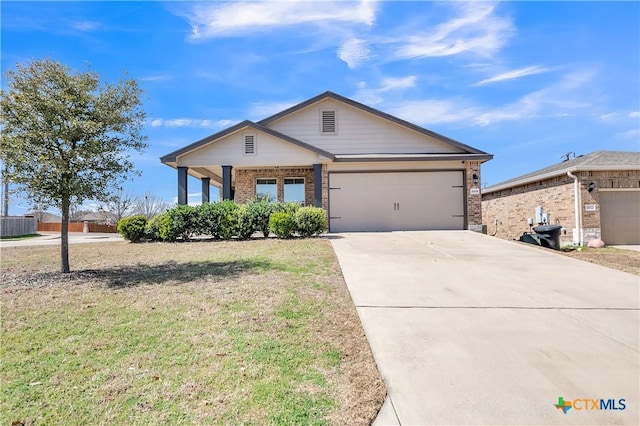 view of front of home with driveway, an attached garage, a front yard, and brick siding