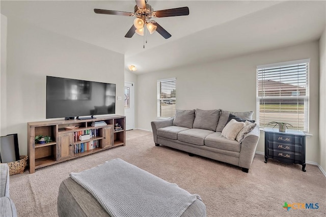 carpeted living area featuring lofted ceiling, ceiling fan, and baseboards