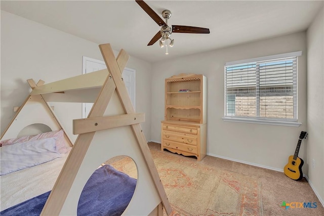 bedroom with a ceiling fan, light colored carpet, and baseboards