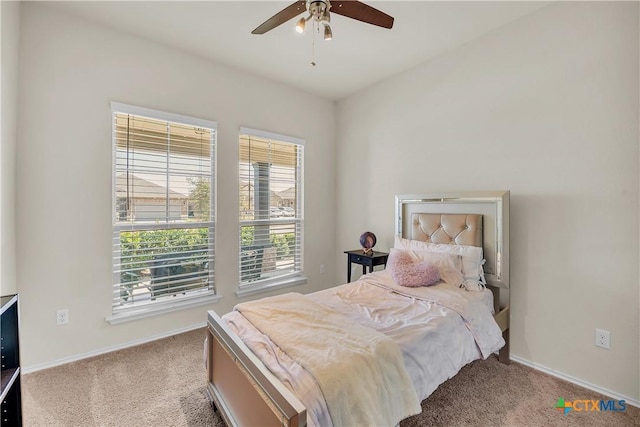 carpeted bedroom with baseboards and a ceiling fan