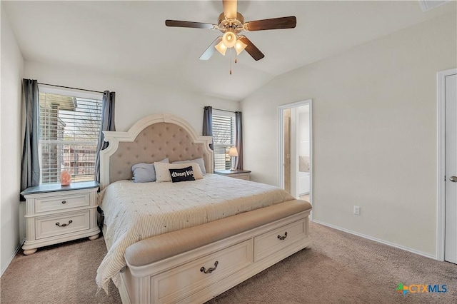 bedroom featuring lofted ceiling, ceiling fan, ensuite bathroom, baseboards, and carpet