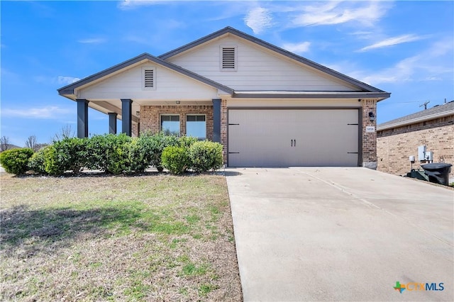 view of front facade featuring a garage, concrete driveway, brick siding, and a front lawn