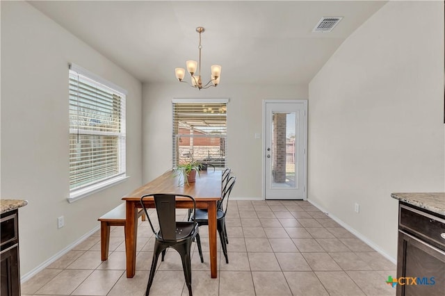 dining area with light tile patterned floors, baseboards, visible vents, and an inviting chandelier